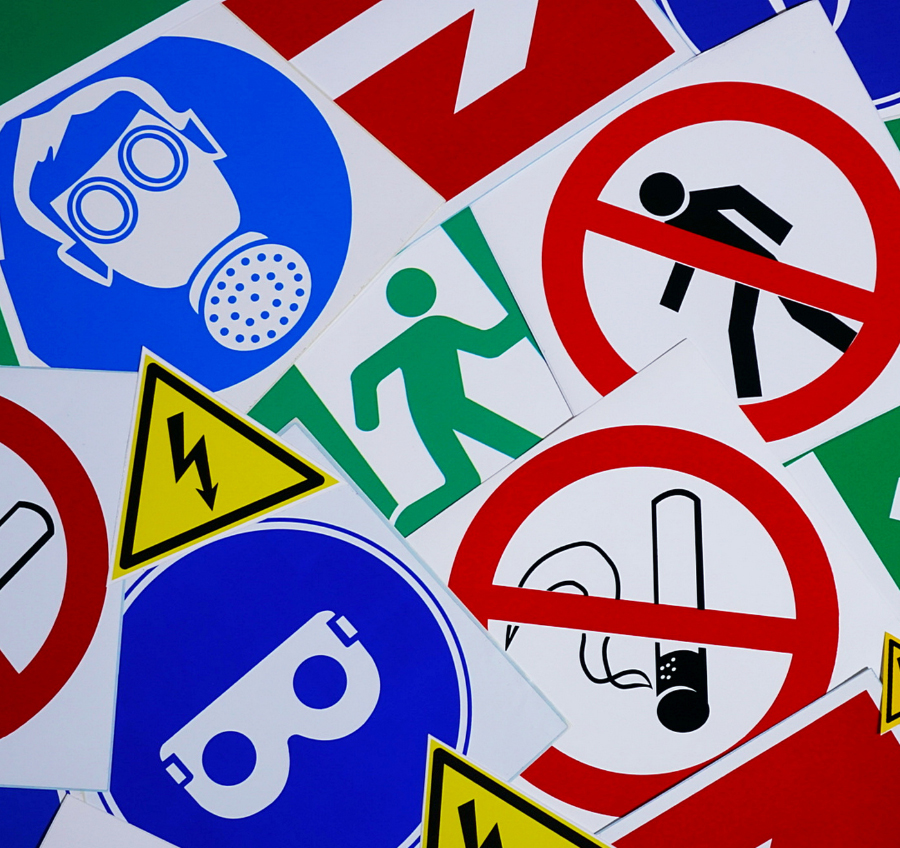 Health and Safety Signs displayed on a wall in a workplace environment